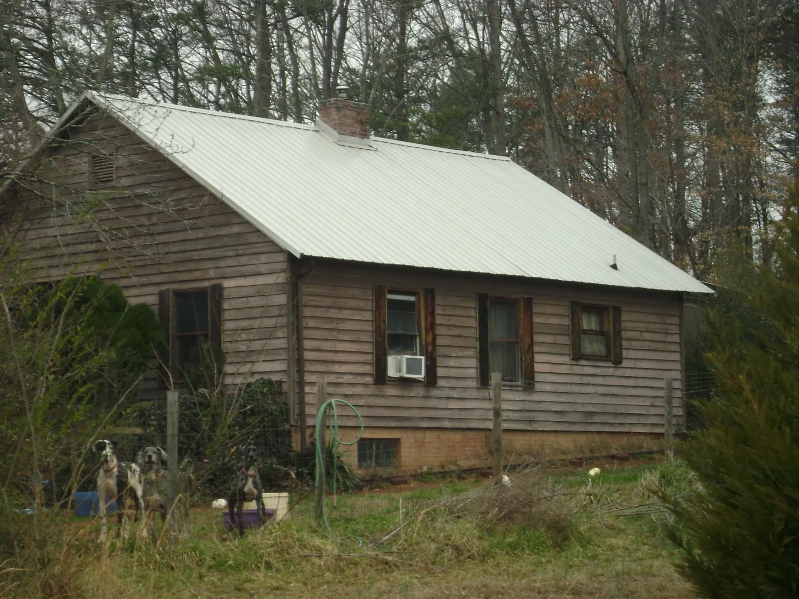 White metal roof on an old wood sided farmhouse, from a Metal Roof Installation job in Wallis